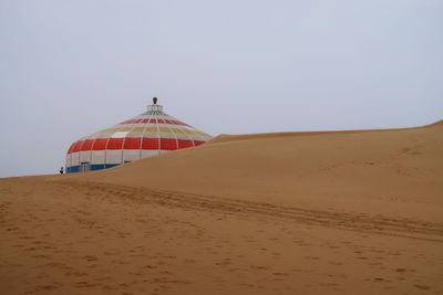 Sand dunes in desert against clear sky