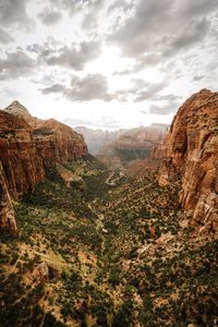 Rock formations on landscape against cloudy sky