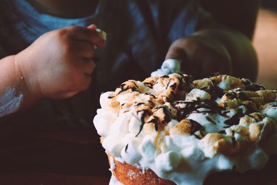 Midsection of child having dessert