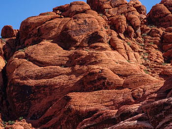 Low angle view of rocks on mountain against sky