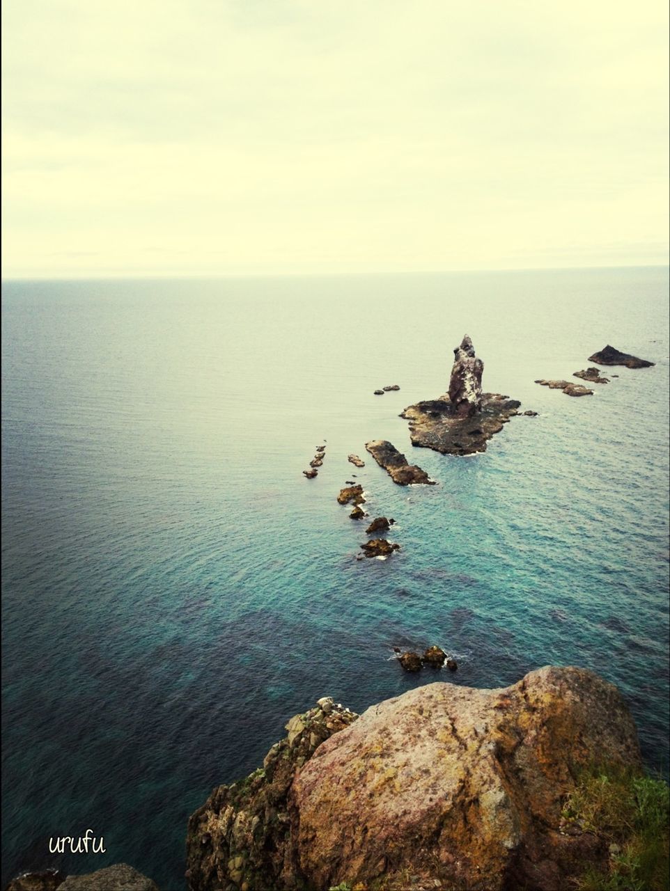 sea, water, horizon over water, scenics, rock - object, tranquility, tranquil scene, beauty in nature, nautical vessel, sky, nature, transportation, mode of transport, rock formation, idyllic, high angle view, boat, rock, cliff, seascape