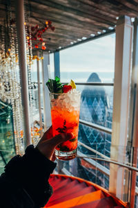 Close-up of hand holding glass of drink