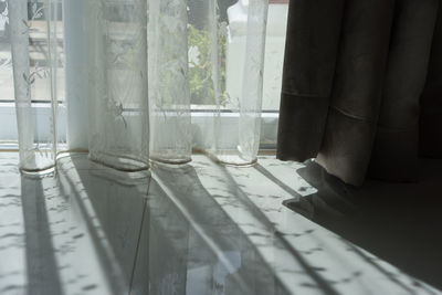 Low section of curtain on window sill at home