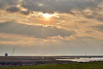 Scenic view of field against sky during sunset