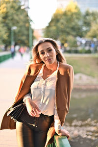 Portrait of smiling young woman standing outdoors