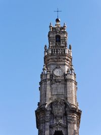 Low angle view of clock tower against blue sky