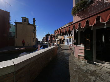 Street amidst buildings against sky