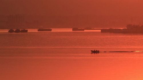 Silhouette boat against clear sky during sunset