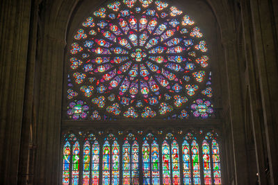 Low angle view of multi colored glass window in building