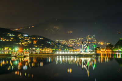 The life electric monument and the como breakwater, on a summer night. the city of como.