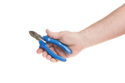 Close-up of hand holding eyeglasses against white background