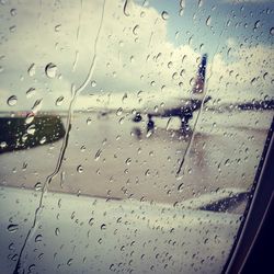 View of road seen through wet windshield