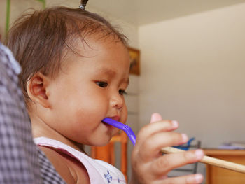Close-up of cute baby girl drinking from straw