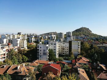 Cityscape against clear blue sky