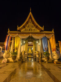 Illuminated temple building against sky at night
