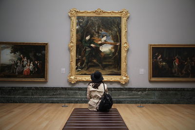 Woman standing by statue
