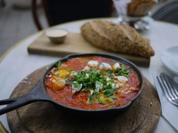 Close-up of shakshouka in cooking pan on table