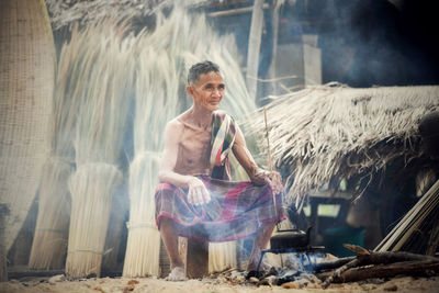 Smiling man sitting outdoors