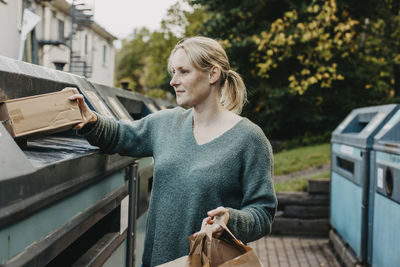 Woman recycling rubbish