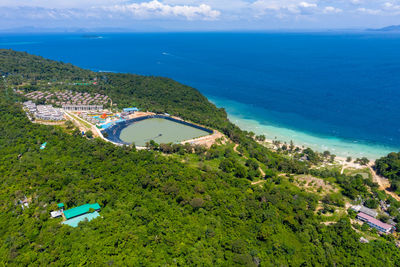 High angle view of townscape by sea against sky