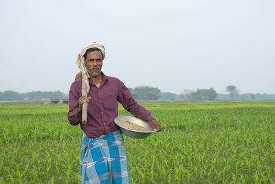 Full length of man standing in farm