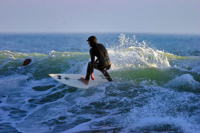 Full length of man surfing in sea