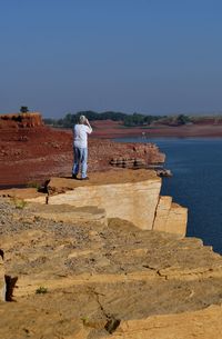 Woman standing at the edge of cliff