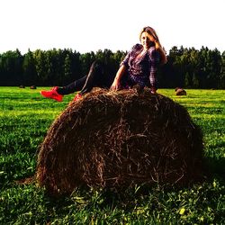 Full frame shot of hay bales on field against sky