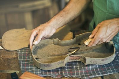 Midsection of man working in workshop