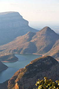 Scenic view of sea and mountains against sky