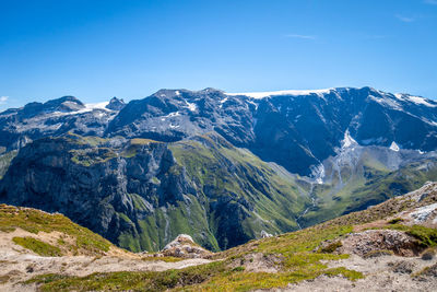 Scenic view of snowcapped mountains against clear blue sky