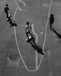 High angle view of people skateboarding on road