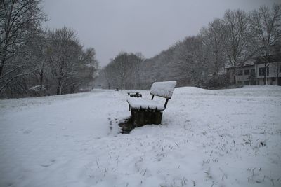 Snow on field against sky during winter