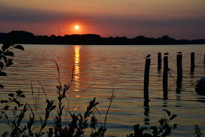 Scenic view of lake against sky during sunset