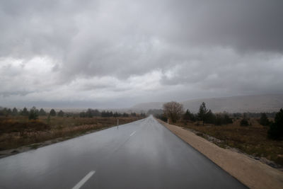 Empty road along countryside landscape