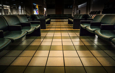 Empty chairs in tiled floor