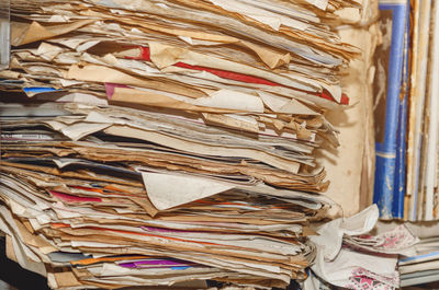 Documents, old papers in folders on shelves are stacked in a mess