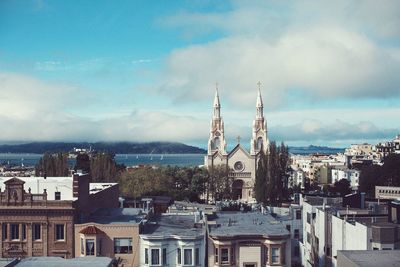 Cityscape against cloudy sky