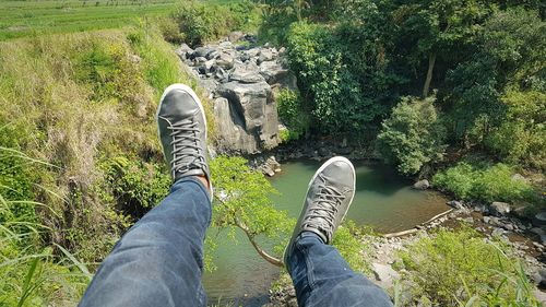 Low section of man relaxing on land