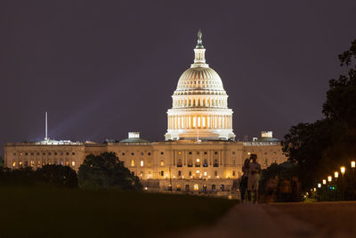 Illuminated building against sky at night