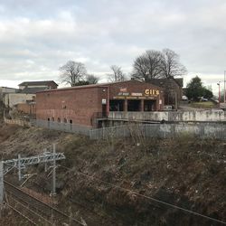 Bare trees against built structures