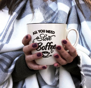 Midsection of woman holding coffee cup