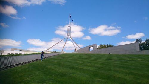 Low angle view of flag at parliament house against sky
