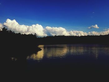 Silhouette landscape against calm lake