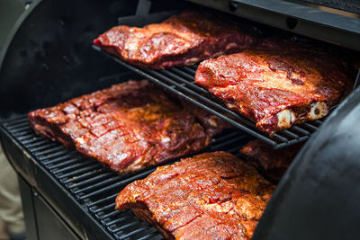 High angle view of beef ribs cooking in barbecue grill