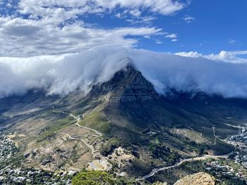 Table mountain under tablecloth clouds as seen from lionshead in cape town, south africa