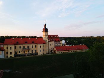 Buildings in city against sky during sunset