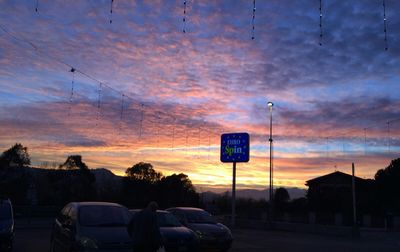 Road against cloudy sky at sunset