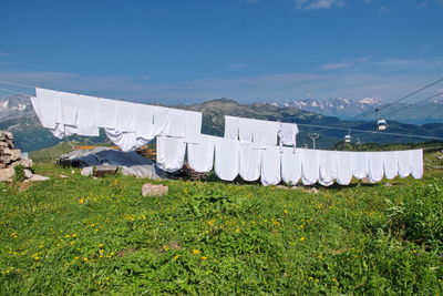 Clothes and sheets drying in the sun on mountain hut in brenta dolomites, italy