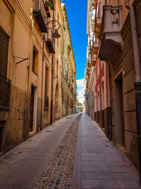 Empty alley amidst buildings in town